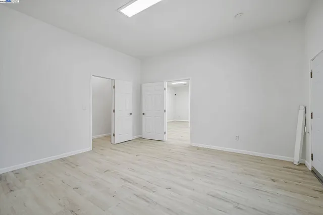 a view of an empty room and wooden floor