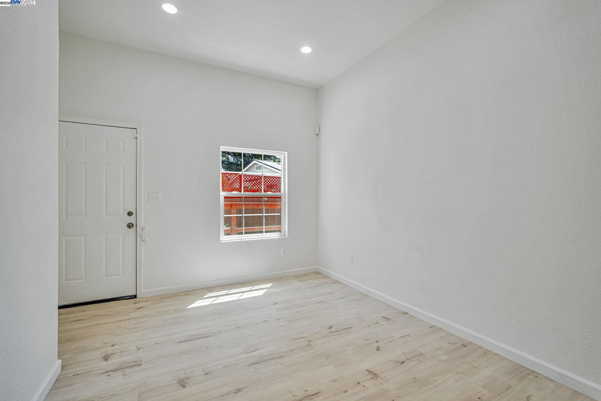 3920 Gravenstein Highway South Sebastopol, CA 95472 - Photo 23 of 48 an empty room with wooden floor and windows