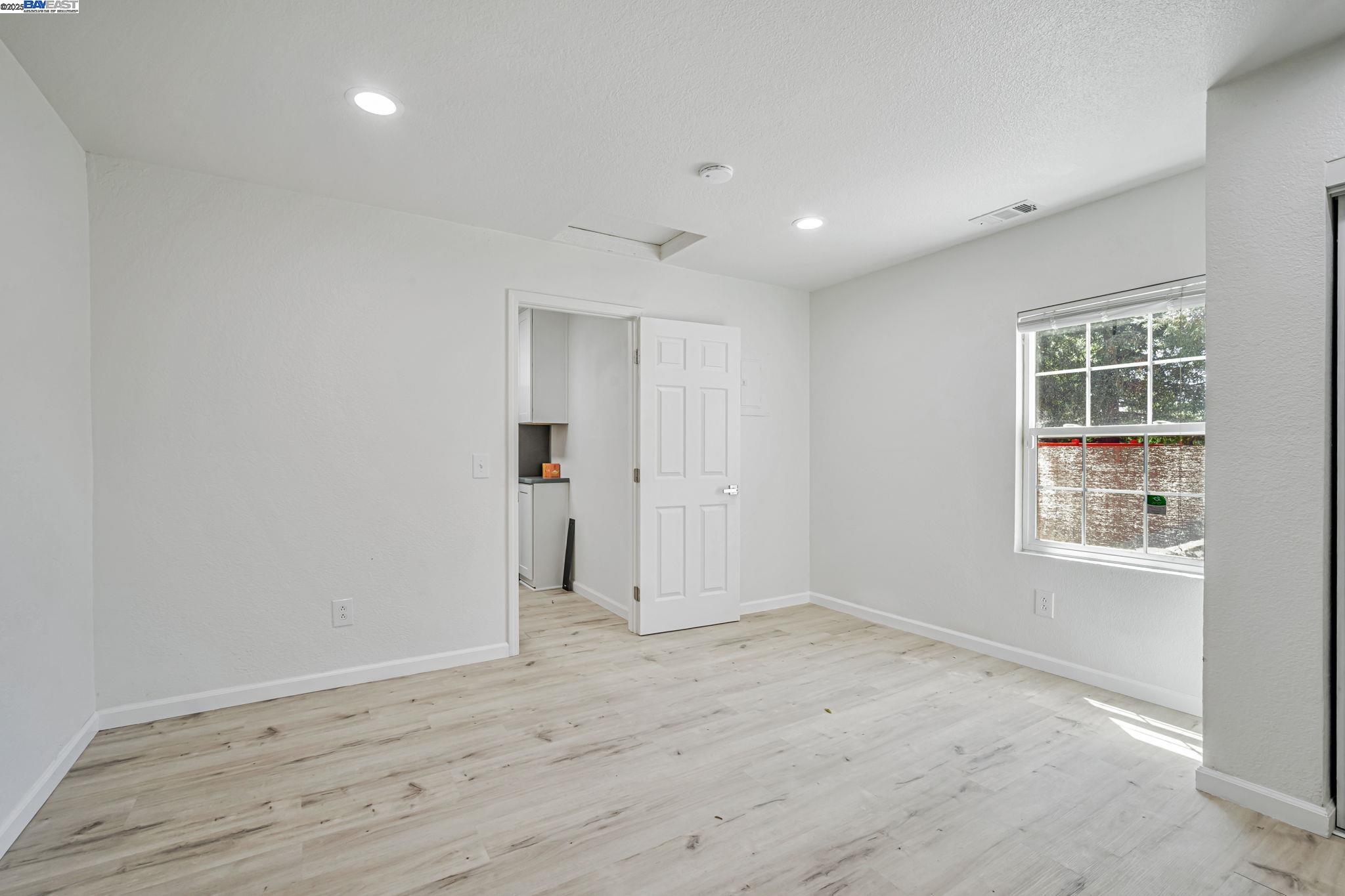 3920 Gravenstein Highway South Sebastopol, CA 95472 - Photo 26 of 48 an empty room with wooden floor and windows