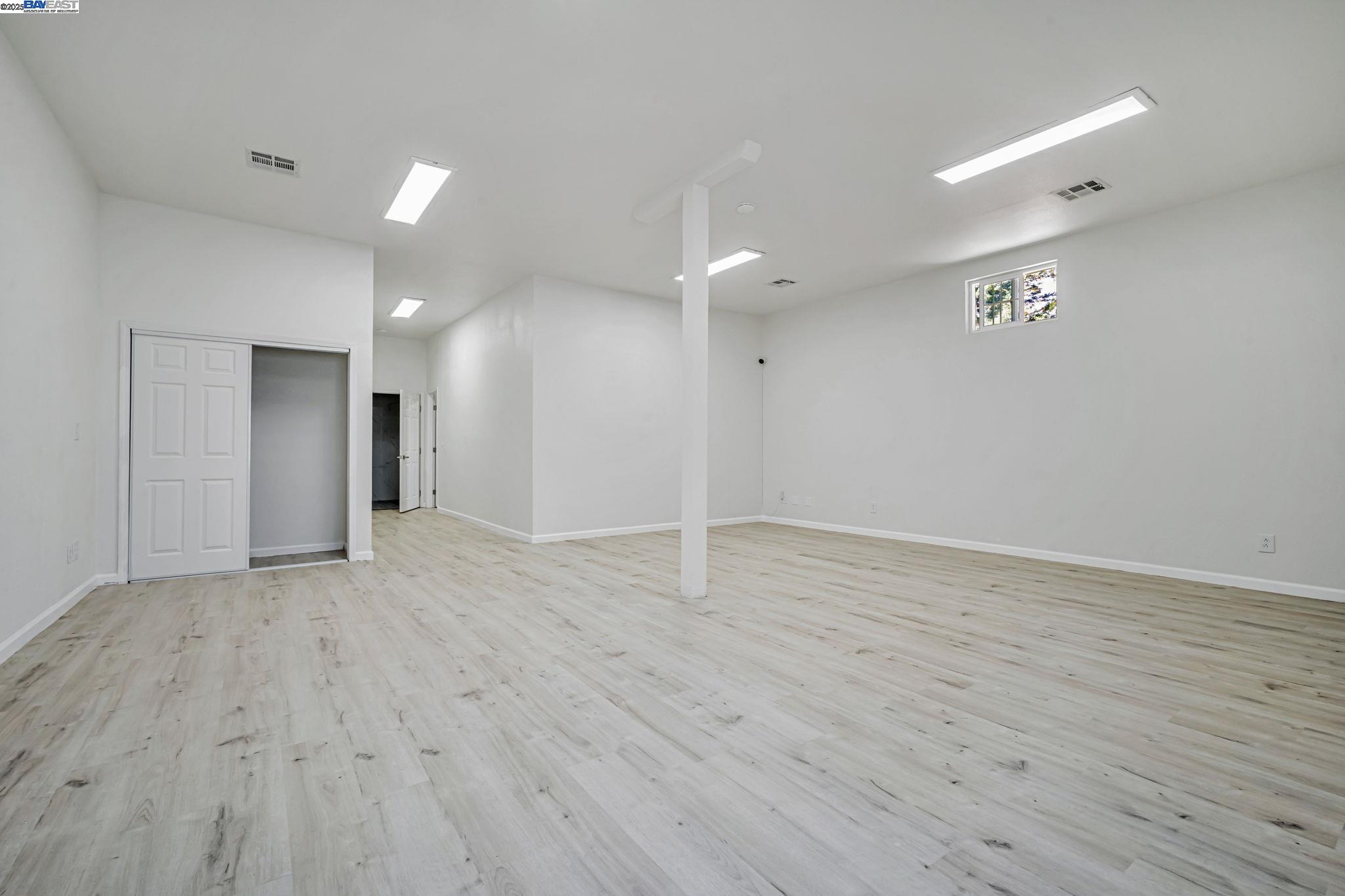 3920 Gravenstein Highway South Sebastopol, CA 95472 - Photo 27 of 48 a view of an empty room with wooden floor and a window