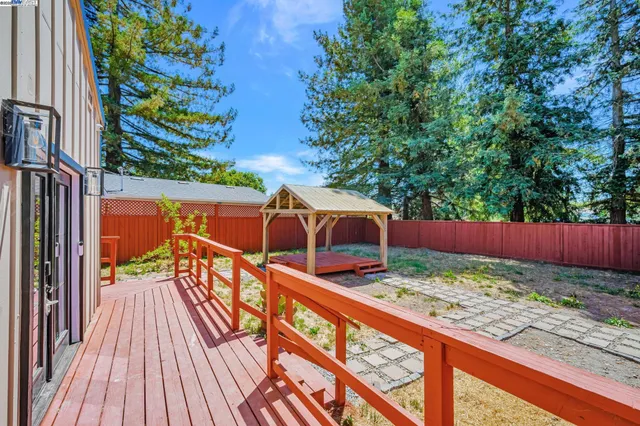 a view of an outdoor sitting area with wooden fence
