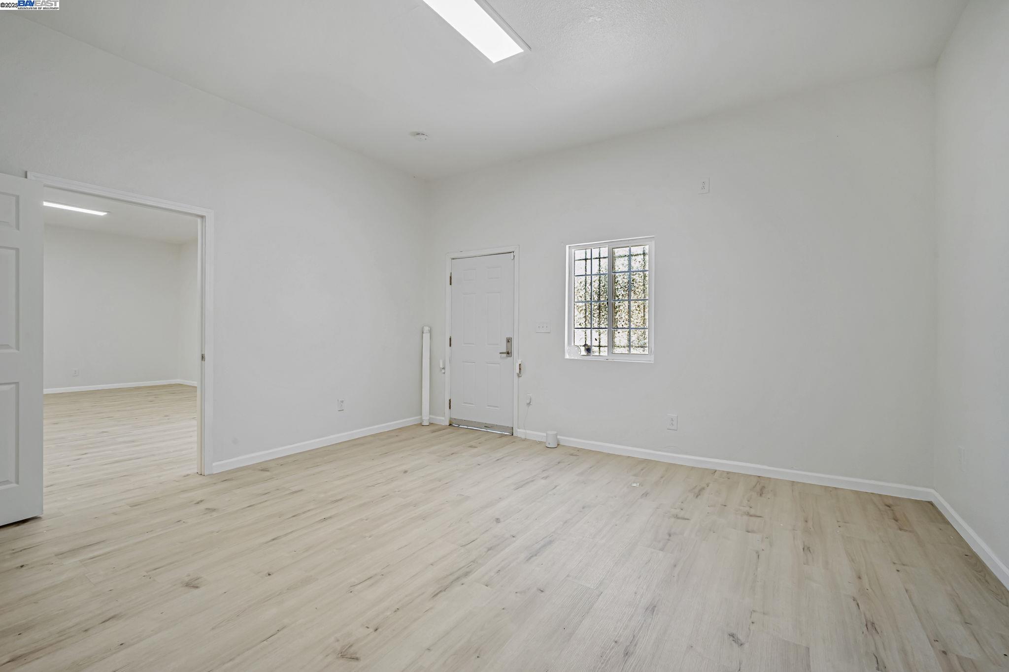 3920 Gravenstein Highway South Sebastopol, CA 95472 - Photo 5 of 48 an empty room with wooden floor and windows