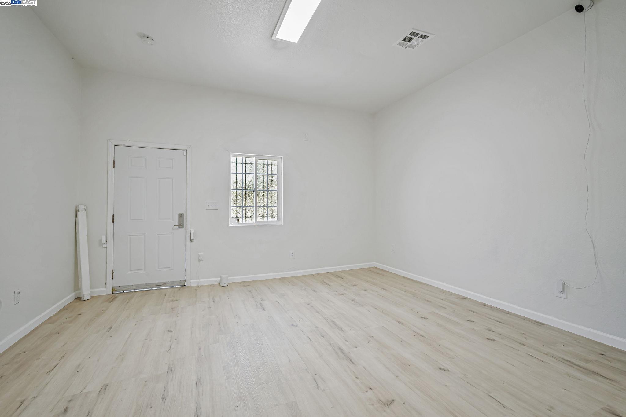 3920 Gravenstein Highway South Sebastopol, CA 95472 - Photo 6 of 48 an empty room with wooden floor and windows