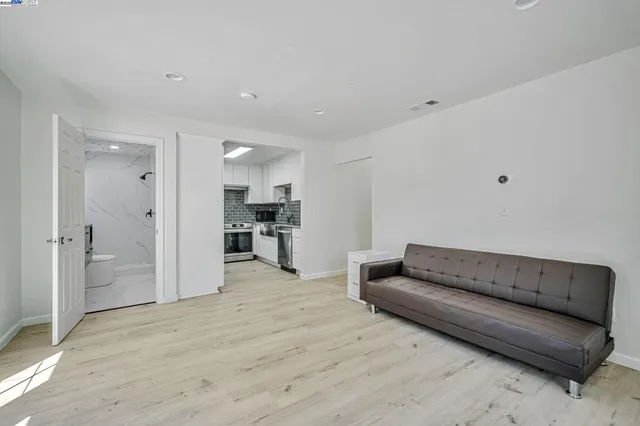 a living room with a couch and a refrigerator
