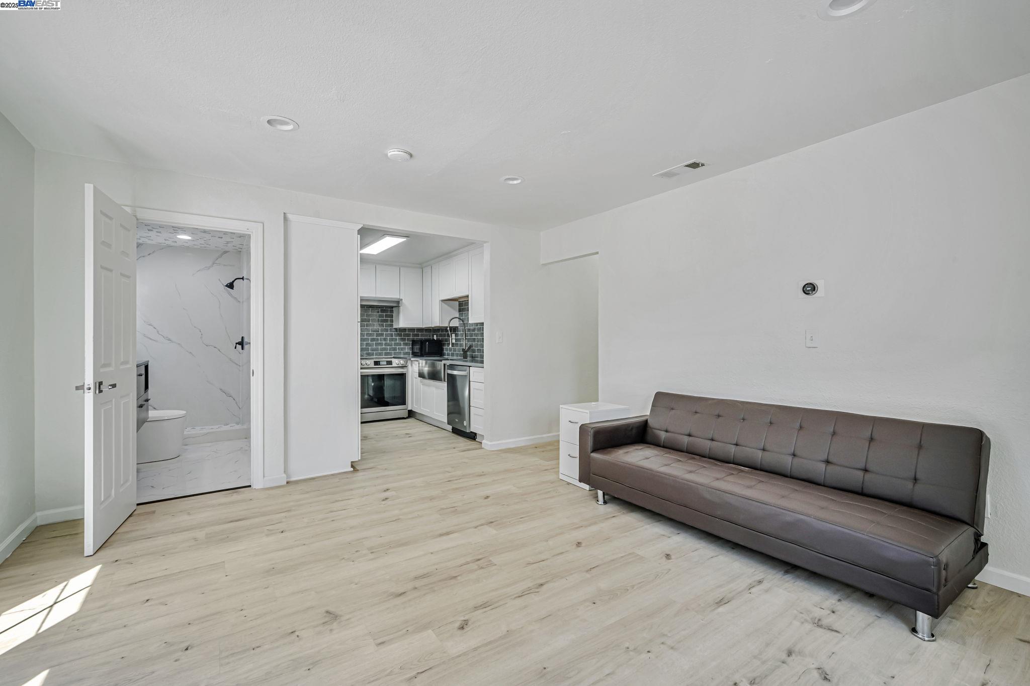 3920 Gravenstein Highway South Sebastopol, CA 95472 - Photo 9 of 48 a living room with a couch and a refrigerator
