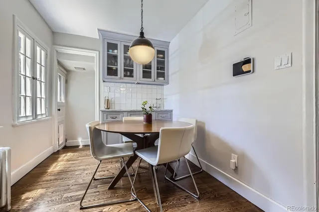 a view of a dining room with furniture and wooden floor