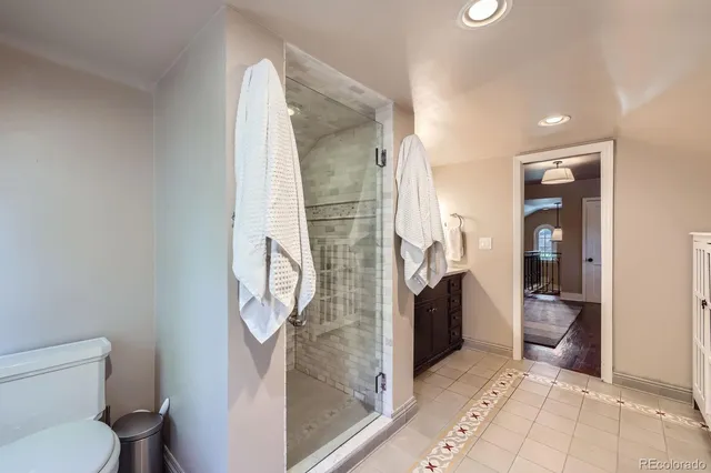 a bathroom with a toilet and a shower