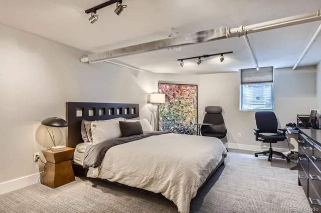 a bed room with a bed and a chair