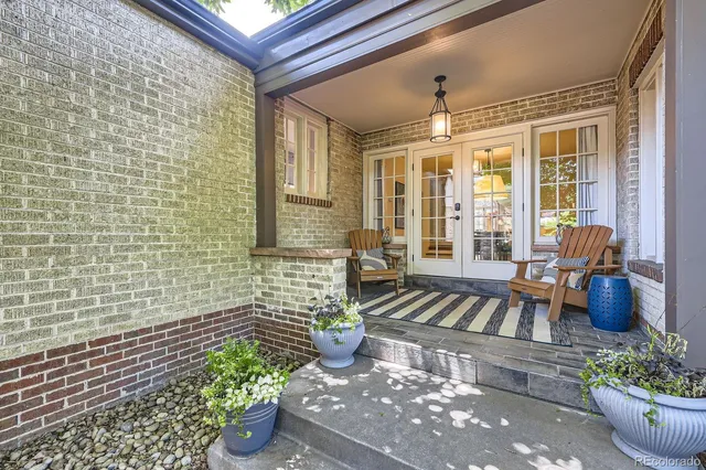 a view of a patio with chairs and potted plants