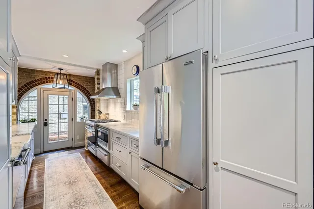 a kitchen with stainless steel appliances a refrigerator sink and cabinets