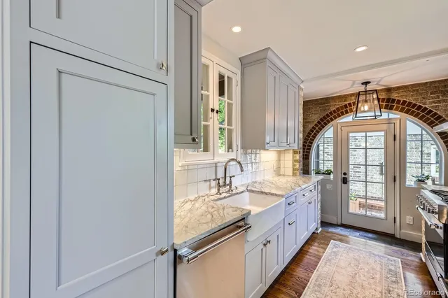a spacious en suite bathroom with a double vanity sink a mirror and a shower