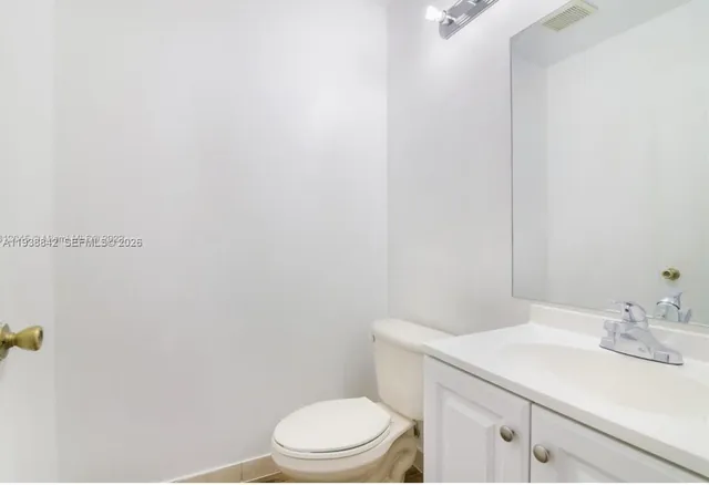 a bathroom with a sink a toilet and vanity
