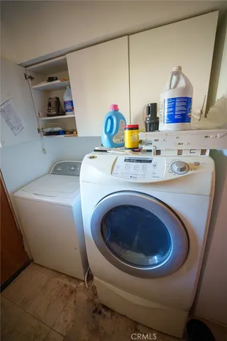 a utility room with sink dryer and washer