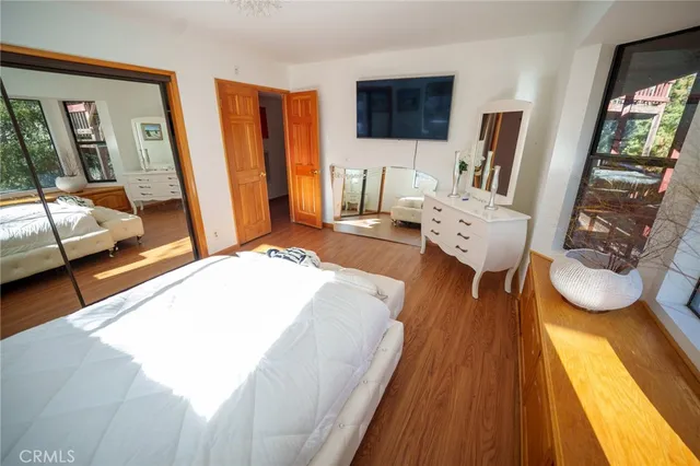 a bedroom with a bed and wooden floor
