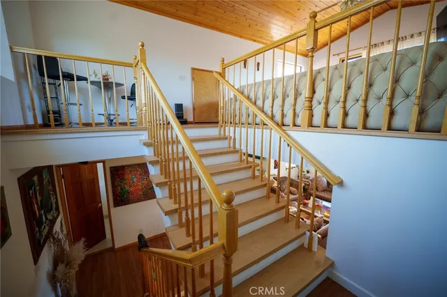 a view of entryway with wooden floor and stairs