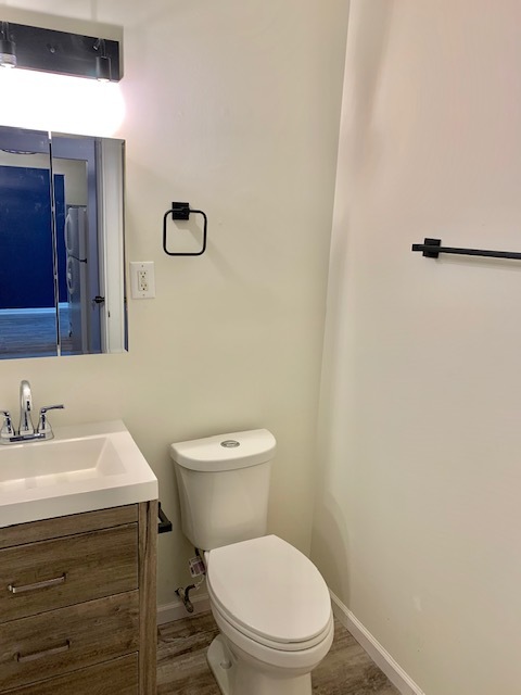 879 Trace Drive, Unit 202 Buffalo Grove, IL 60089 - Photo 16 of 18 a bathroom with a toilet a sink and mirror