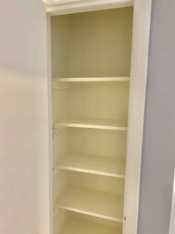 a close view of closet with wooden floor