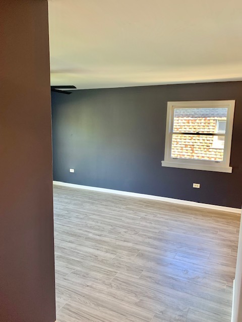 879 Trace Drive, Unit 202 Buffalo Grove, IL 60089 - Photo 7 of 18 a view of an empty room with wooden floor and a window