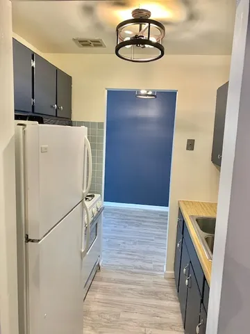 a kitchen with stainless steel appliances a refrigerator and a stove