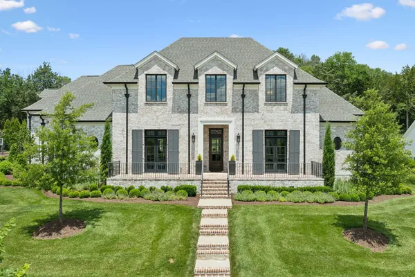 a front view of a house with a yard