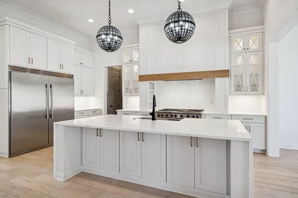 a kitchen with stainless steel appliances granite countertop a stove and a refrigerator