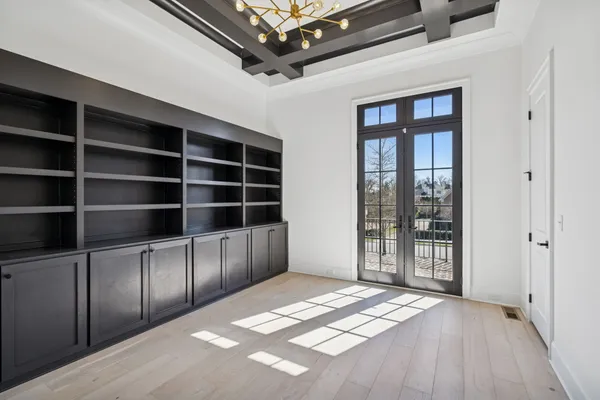an empty room with a window and a ceiling fan