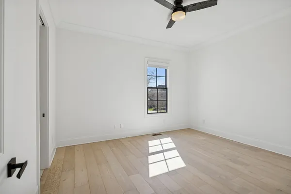 a view of a patio with couches potted plants and a big yard