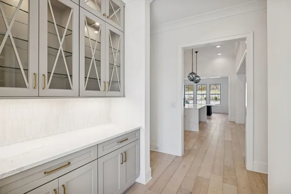 a view of empty room with wooden floor and fireplace