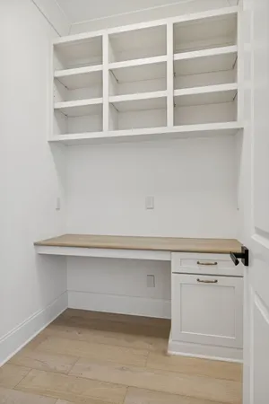 a view of an empty room with a fireplace and a window