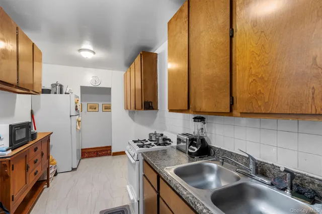 a kitchen with stainless steel appliances a sink a stove and a refrigerator