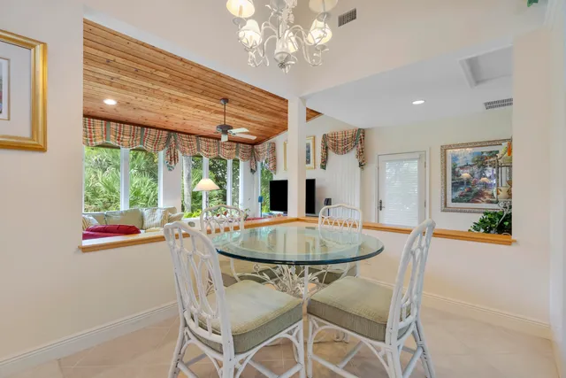 a view of a dining room with furniture and a chandelier