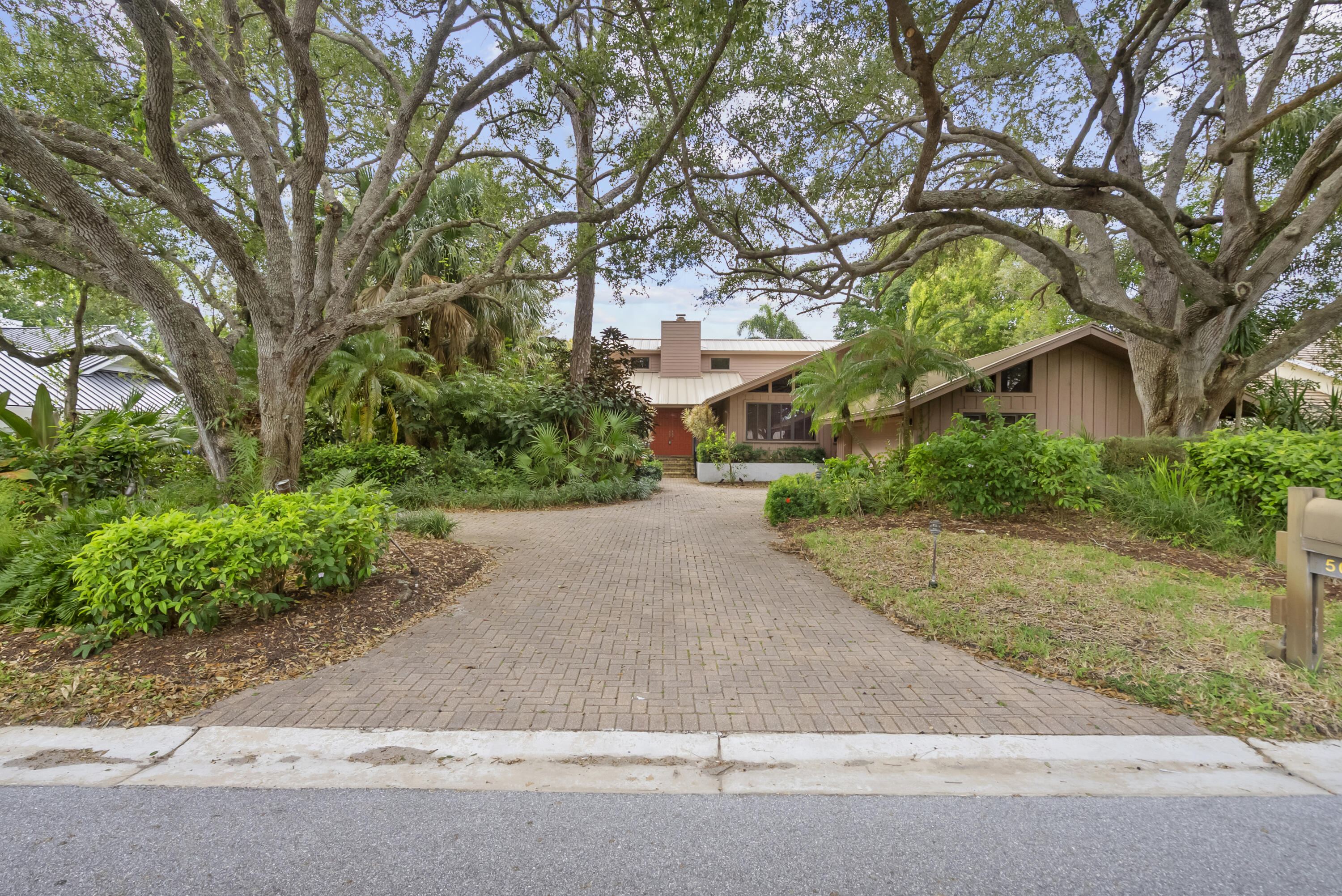 5011 Southeast Burning Tree Circle Stuart, FL 34997 - Photo 2 of 58 a view of road and trees around