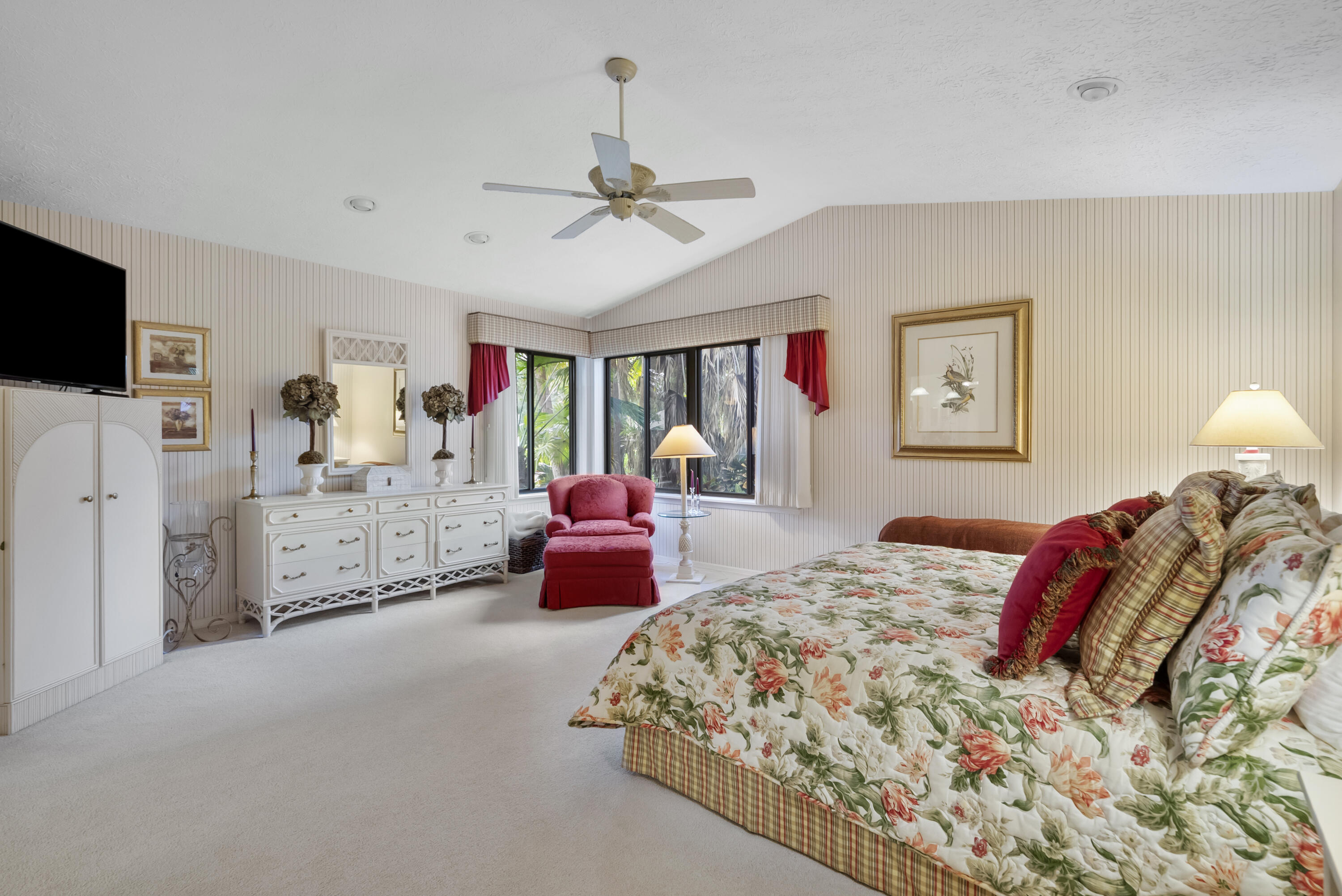 5011 Southeast Burning Tree Circle Stuart, FL 34997 - Photo 25 of 58 a bedroom with bed and ceiling fan