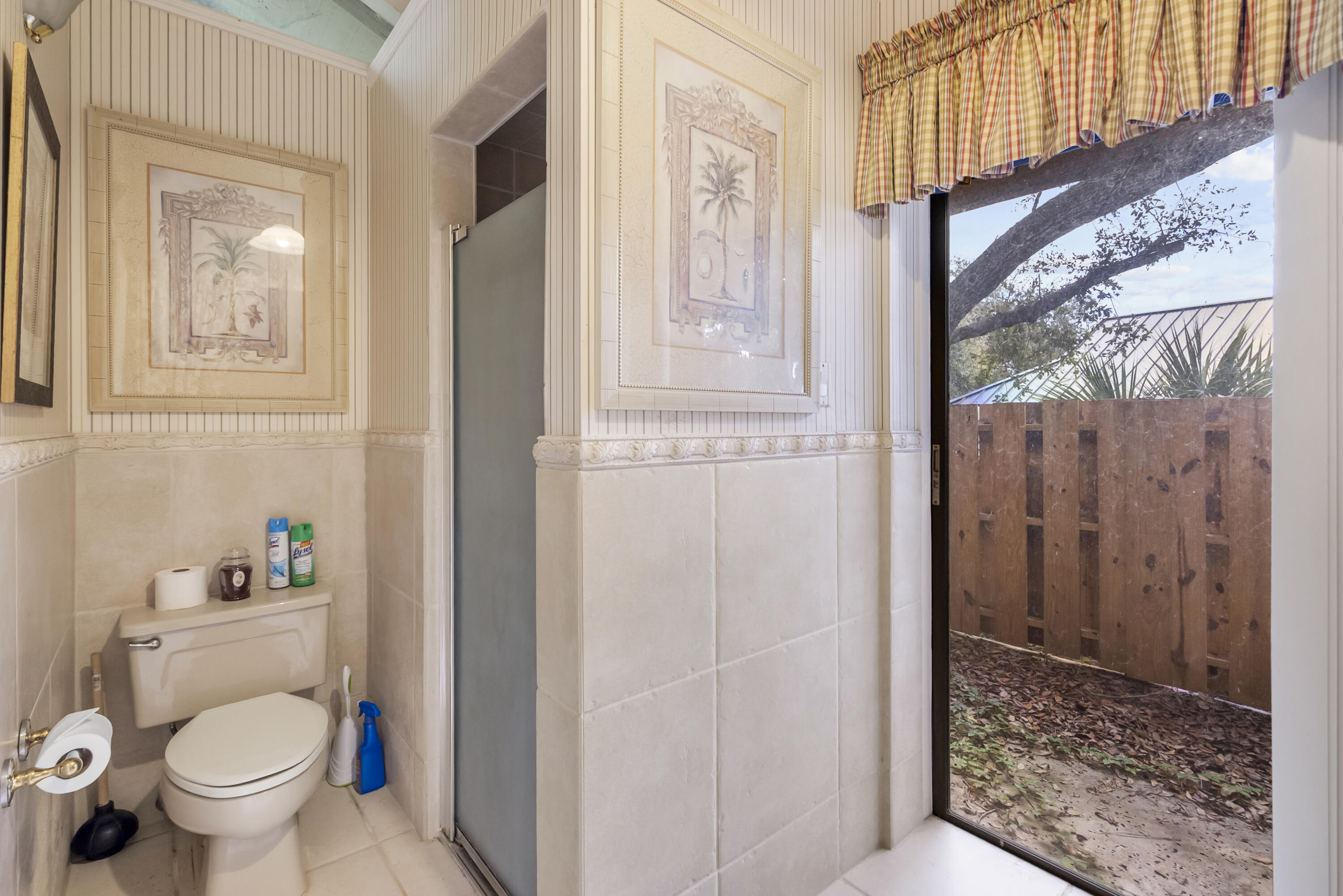 5011 Southeast Burning Tree Circle Stuart, FL 34997 - Photo 29 of 58 a bathroom with a toilet and a shower