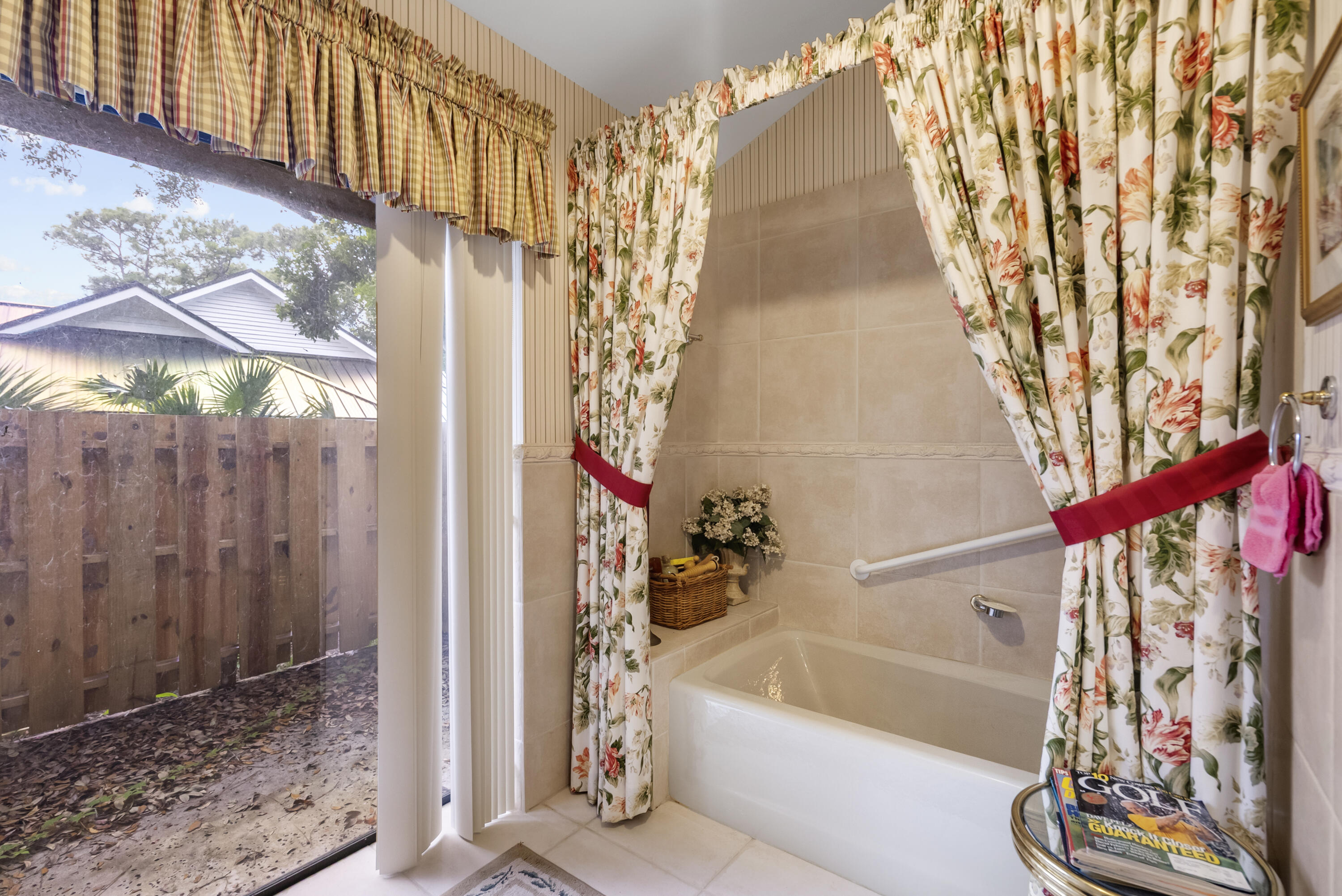 5011 Southeast Burning Tree Circle Stuart, FL 34997 - Photo 30 of 58 a bathroom with a bathtub and shower