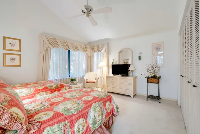 a bedroom with two beds and a couch