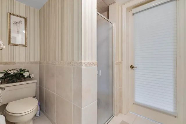 a bathroom with a toilet sink and shower