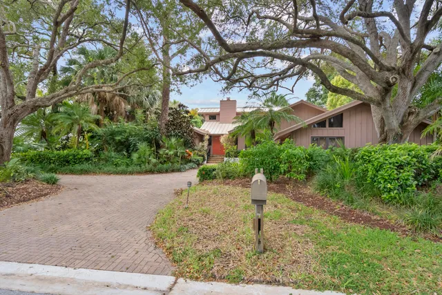 a front view of a house with a yard and a garage