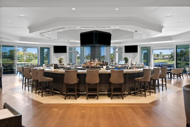 a view of a dining room with furniture a chandelier and wooden floor