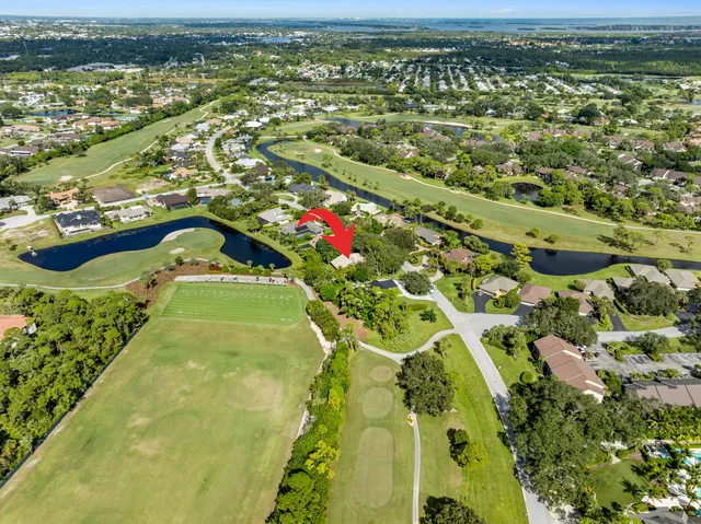 an aerial view of residential houses with outdoor space and river