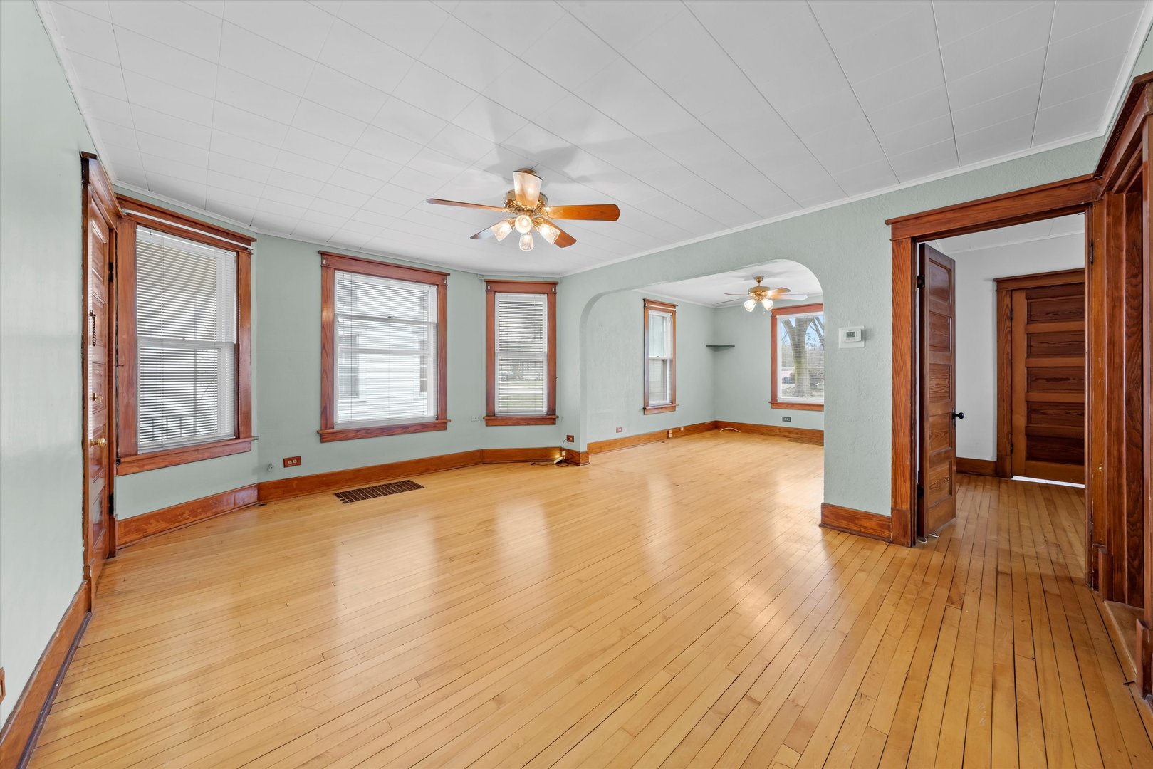 1443 Main Street Crete, IL 60417 - Photo 4 of 19 a view of an empty room with window and wooden floor