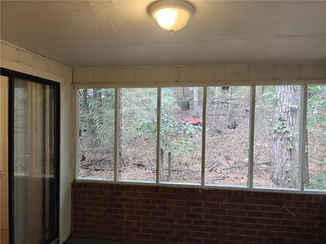 a view of wooden floor and windows in a room