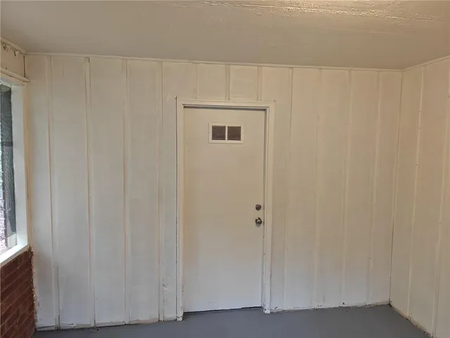 a bathroom with a shower and a door
