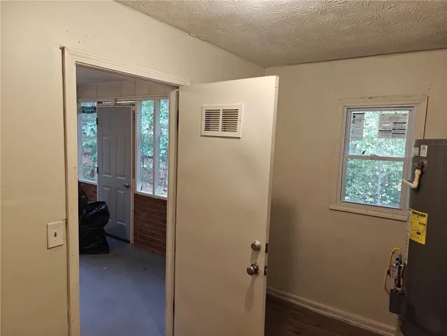 a view of a hallway with living room and a window