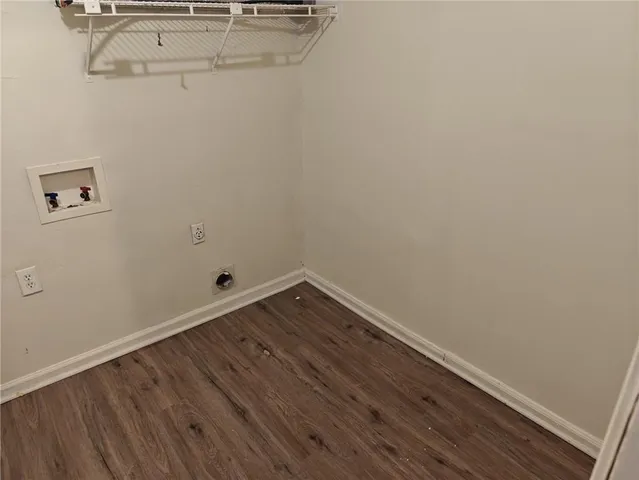 a room with a bench and wooden floor