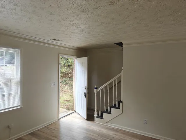 a view of entryway with stairs and wooden floor