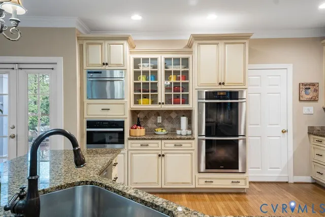 a en suite bathroom with a double vanity sink a toilet and a mirror