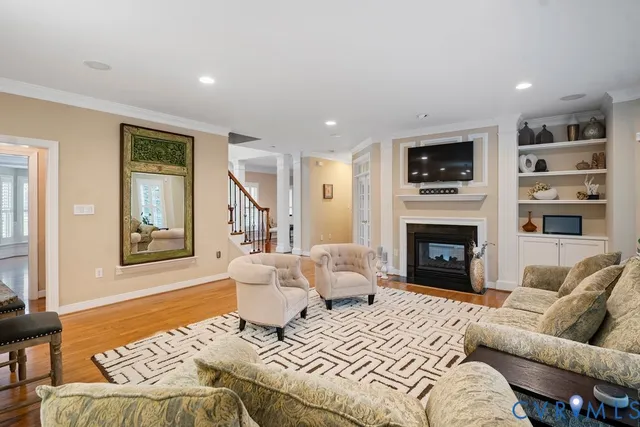 a kitchen with stainless steel appliances granite countertop a stove top oven a sink dishwasher and white cabinets with wooden floor