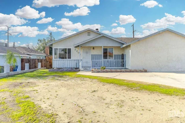 a view of a backyard with potted plants and wooden fence