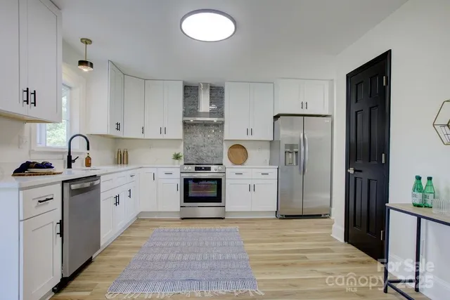 a kitchen with a refrigerator sink and stove